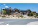 Community clubhouse features solar panels and is surrounded by beautiful landscaping for a welcoming atmosphere at 18926 W 94Th Ave, Arvada, CO 80007