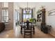 Elegant dining room featuring hardwood floors, chandelier lighting, and large windows with neighborhood views at 18926 W 94Th Ave, Arvada, CO 80007