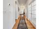 Long hallway features hardwood floors, white walls, and arched doorways at 18926 W 94Th Ave, Arvada, CO 80007