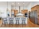 Modern kitchen with stainless steel appliances, granite countertops, and pendant lighting at 18926 W 94Th Ave, Arvada, CO 80007