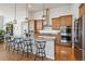 Spacious kitchen with granite countertops, stainless steel appliances, and a breakfast bar at 18926 W 94Th Ave, Arvada, CO 80007