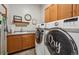 Laundry room with modern washer and dryer, ample cabinet space, and a sink at 18926 W 94Th Ave, Arvada, CO 80007
