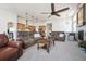Open-concept living room and kitchen area with hardwood floors, pendant lighting, and comfortable couches at 18926 W 94Th Ave, Arvada, CO 80007