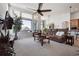 Cozy living room filled with natural light from large windows, comfortable seating, and a ceiling fan at 18926 W 94Th Ave, Arvada, CO 80007