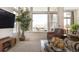 Bright living room with large windows and neighborhood views plus comfortable seating and neutral carpet at 18926 W 94Th Ave, Arvada, CO 80007