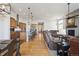 Open concept featuring living room, kitchen and dining areas with hardwood floors, neutral carpet, and pendant lighting at 18926 W 94Th Ave, Arvada, CO 80007
