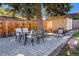 Backyard brick patio featuring an outdoor dining set and a small shed at 90 Ammons St, Lakewood, CO 80226