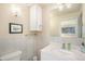 Neutral toned bathroom with white cabinets, tile, and modern fixtures at 90 Ammons St, Lakewood, CO 80226