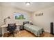 Well-lit bedroom featuring a desk and chair with hardwood floors and natural lighting at 90 Ammons St, Lakewood, CO 80226