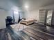 Cozy bedroom with wood flooring, a sitting area, and modern furniture at 90 Ammons St, Lakewood, CO 80226