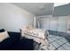 Finished basement bedroom with a large bed, sitting area, and wood-style flooring at 90 Ammons St, Lakewood, CO 80226