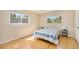 Bright bedroom with hardwood floors, two windows, and neutral walls at 90 Ammons St, Lakewood, CO 80226