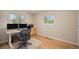 Bright bedroom featuring wood floors, natural light, and a work space at 90 Ammons St, Lakewood, CO 80226