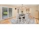Bright dining room with sliding glass doors, stylish lighting, and an adjacent patio at 90 Ammons St, Lakewood, CO 80226