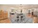 Bright dining room featuring hardwood floors, modern lighting, and seamless living space at 90 Ammons St, Lakewood, CO 80226