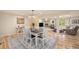 Open concept dining area with hardwood floors and a view into the living room with fireplace at 90 Ammons St, Lakewood, CO 80226
