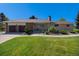 Charming single-story home with brick and stone accents, lush lawn, and a two-car garage at 90 Ammons St, Lakewood, CO 80226