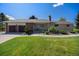 Charming single-story home with brick and stone accents, lush lawn, and a two-car garage at 90 Ammons St, Lakewood, CO 80226