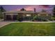 Charming single-story home with brick and stone accents, lush lawn, and a two-car garage at 90 Ammons St, Lakewood, CO 80226