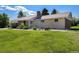 Charming single-story home with brick and stone accents, lush lawn, and a well-kept yard at 90 Ammons St, Lakewood, CO 80226