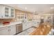 Bright kitchen boasts white cabinets, stainless steel appliances, and a view of the outdoors at 90 Ammons St, Lakewood, CO 80226