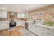 Updated kitchen features stone backsplash, stainless steel appliances, and a bright, airy feel at 90 Ammons St, Lakewood, CO 80226