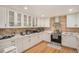 Well-lit kitchen with stainless steel appliances, white cabinets, and marble countertops at 90 Ammons St, Lakewood, CO 80226