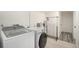 Practical laundry room with modern washer and dryer with a hanging rack at 90 Ammons St, Lakewood, CO 80226