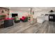 Open basement living area with a fireplace, dining set, and kitchen at 90 Ammons St, Lakewood, CO 80226