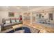 Open-concept living area featuring hardwood floors and seamless flow to dining space at 90 Ammons St, Lakewood, CO 80226