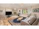 Cozy living room featuring a stone fireplace, hardwood floors, and modern decor at 90 Ammons St, Lakewood, CO 80226