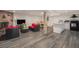 Open basement living area with a fireplace, dining set, and kitchen at 90 Ammons St, Lakewood, CO 80226