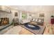 Cozy living room featuring a stone fireplace, hardwood floors, and modern decor at 90 Ammons St, Lakewood, CO 80226