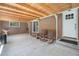 Covered patio featuring exposed wood beams, brick walls, and rocking chairs at 90 Ammons St, Lakewood, CO 80226