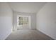 Bright bedroom featuring neutral carpet and a large window for natural light at 1818 S Quebec Way # B15-5, Denver, CO 80231