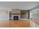 Bright living room with a modern fireplace, sleek hardwood floors, and a large picture window that provides ample natural light at 1818 S Quebec Way # B15-5, Denver, CO 80231