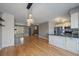 Open concept living area with hardwood floors, kitchen, and view to stairs at 1818 S Quebec Way # B15-5, Denver, CO 80231