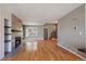Large open-concept living space with hardwood floors, a modern fireplace, and staircase access to the second floor at 1818 S Quebec Way # B15-5, Denver, CO 80231