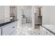 Bright bathroom featuring a deep soaking tub, tiled floors, and sleek vanity with a sink and storage at 1835 Columbine Ave, Boulder, CO 80302