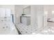 Bright bathroom featuring a deep soaking tub, tiled floors, and sleek vanity with a sink and storage at 1835 Columbine Ave, Boulder, CO 80302