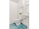 Bright bathroom with white fixtures, pedestal sink, and blue tile flooring with a decorative cabinet at 1835 Columbine Ave, Boulder, CO 80302