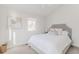 Comfortable bedroom featuring a gray upholstered headboard, fluffy pillows and a large window with natural light at 1835 Columbine Ave, Boulder, CO 80302