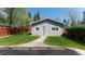 Detached single garage in backyard with a well-manicured lawn and stone pathway at 1835 Columbine Ave, Boulder, CO 80302