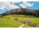 Scenic hiking trail through a vibrant green meadow with stunning mountain views on a sunny day at 1835 Columbine Ave, Boulder, CO 80302