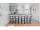 Bright open kitchen with breakfast bar and modern light gray cabinets with seating for four at 1835 Columbine Ave, Boulder, CO 80302