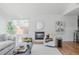 Cozy living room featuring fireplace, plush seating, hardwood floors, and natural light from a large window at 1835 Columbine Ave, Boulder, CO 80302