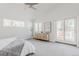 Light-filled main bedroom boasting plush carpeting, a sliding glass door, a ceiling fan and a neutral color scheme at 1835 Columbine Ave, Boulder, CO 80302
