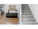 Staircase with gray carpet and white railings, with adjacent sideboard and colorful artwork at 1835 Columbine Ave, Boulder, CO 80302