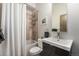 Cozy bathroom featuring a shower-tub combo with decorative tile, a modern vanity, and a neutral color palette at 2103 W 32Nd Ave # 10, Denver, CO 80211