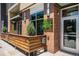 A modern building exterior with brick accents, a colorful flag, and a patio area at 2103 W 32Nd Ave # 10, Denver, CO 80211